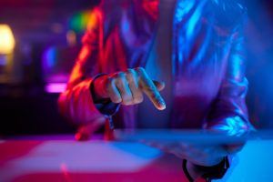 Neon metaverse futuristic concept. Closeup on business woman using tablet PC.