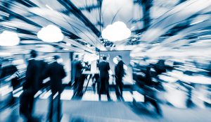 blurred anonymous people walking in a modern hall